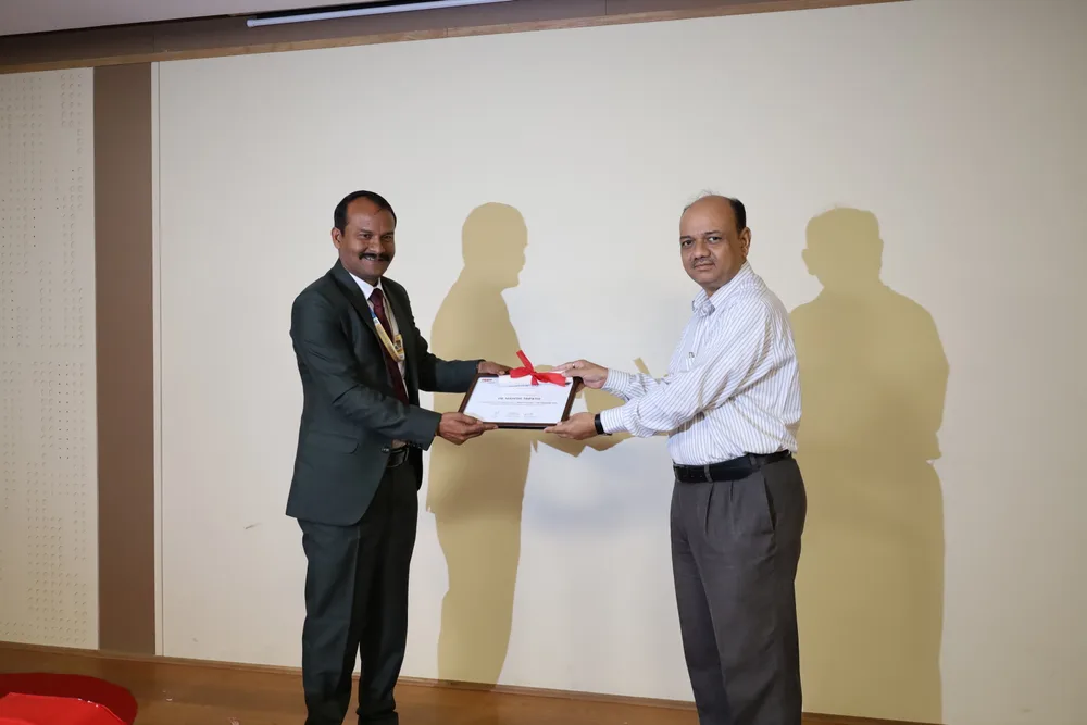 A certificate of appreciation being presented to a guest